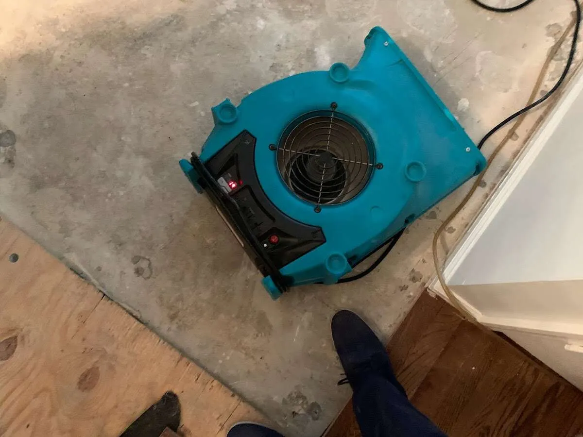 Air mover drying subfloor during Leak Detection & Repair in Lennox